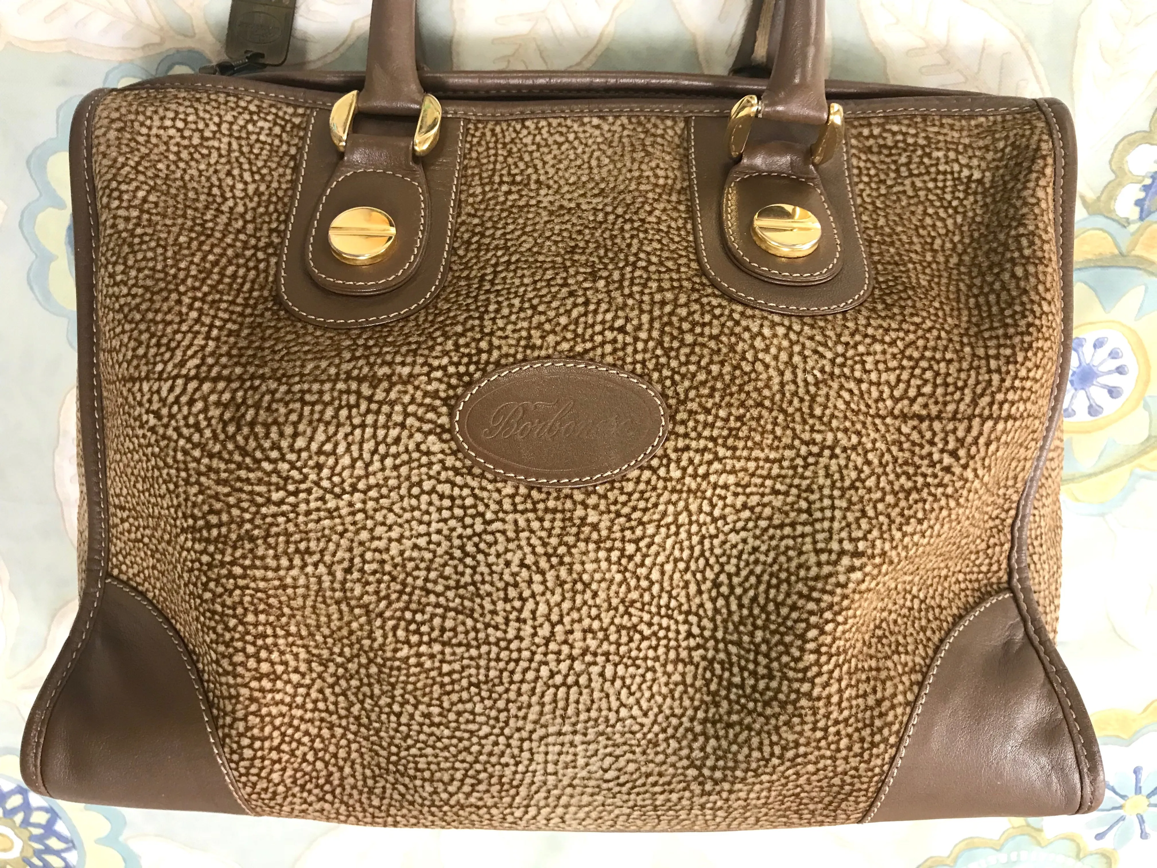 Vintage Borbonese by red wall, brown and beige leather classic bag with golden logo charm.  Unisex use. Masterpiece.