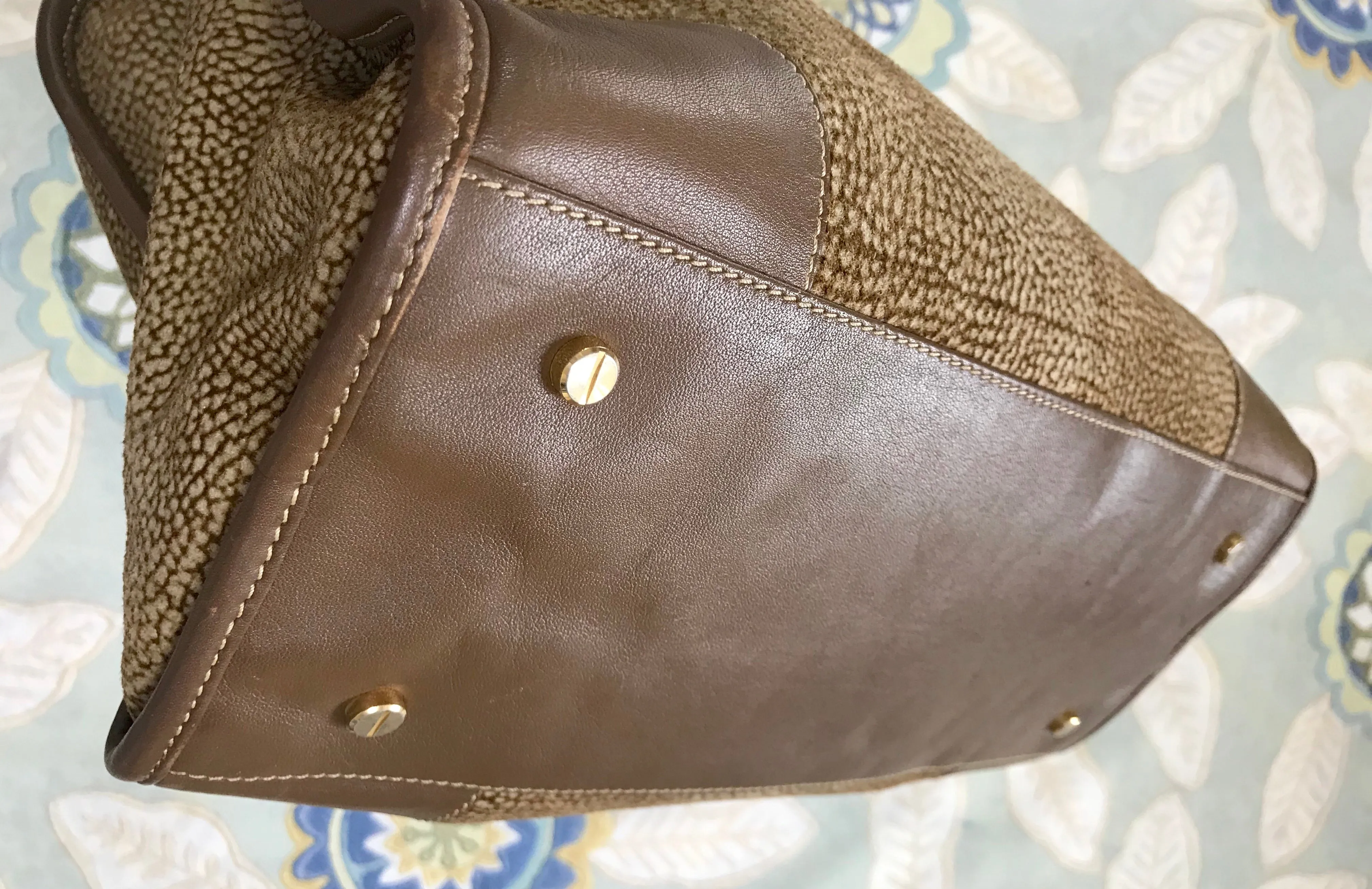Vintage Borbonese by red wall, brown and beige leather classic bag with golden logo charm.  Unisex use. Masterpiece.