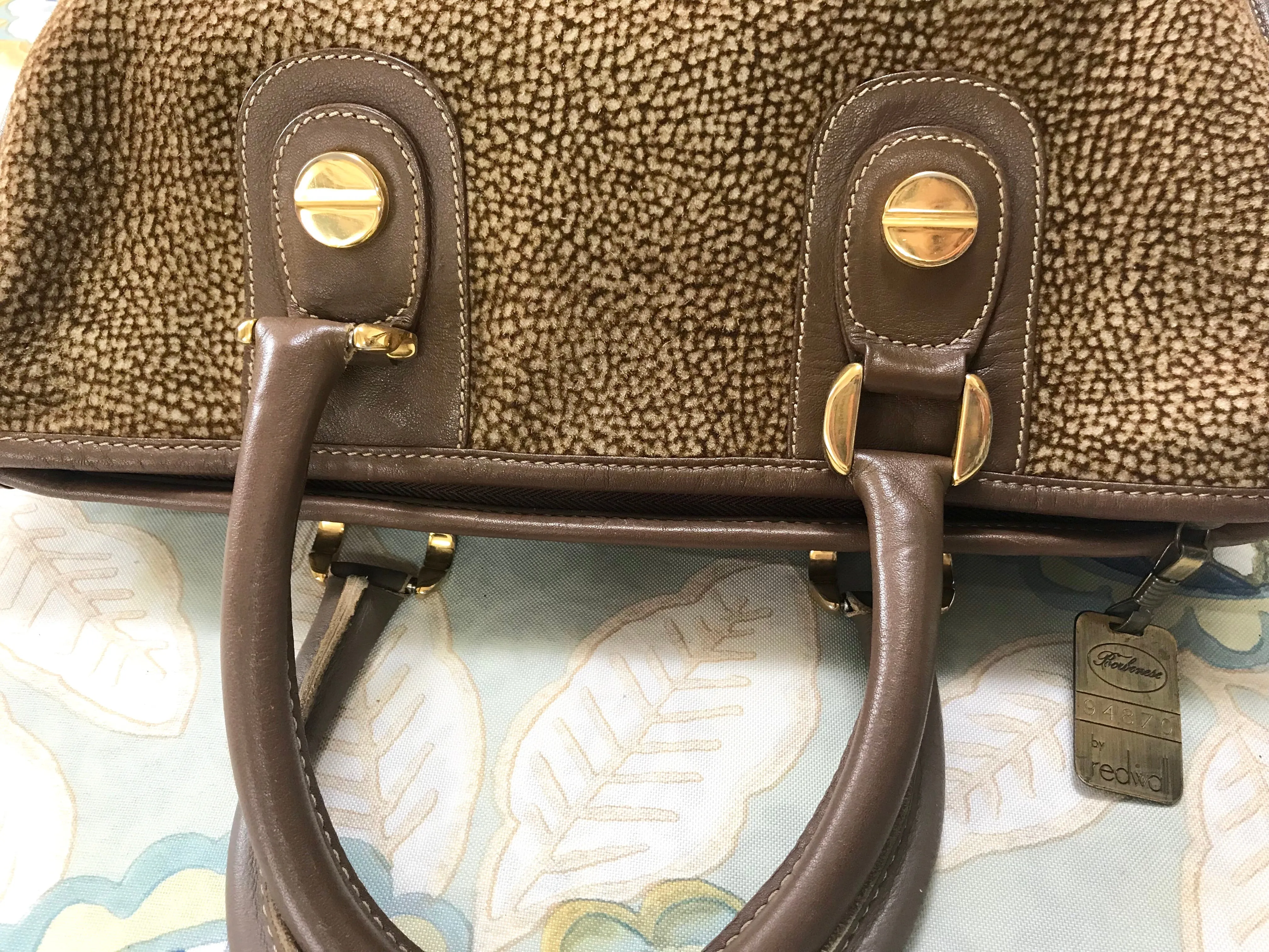 Vintage Borbonese by red wall, brown and beige leather classic bag with golden logo charm.  Unisex use. Masterpiece.