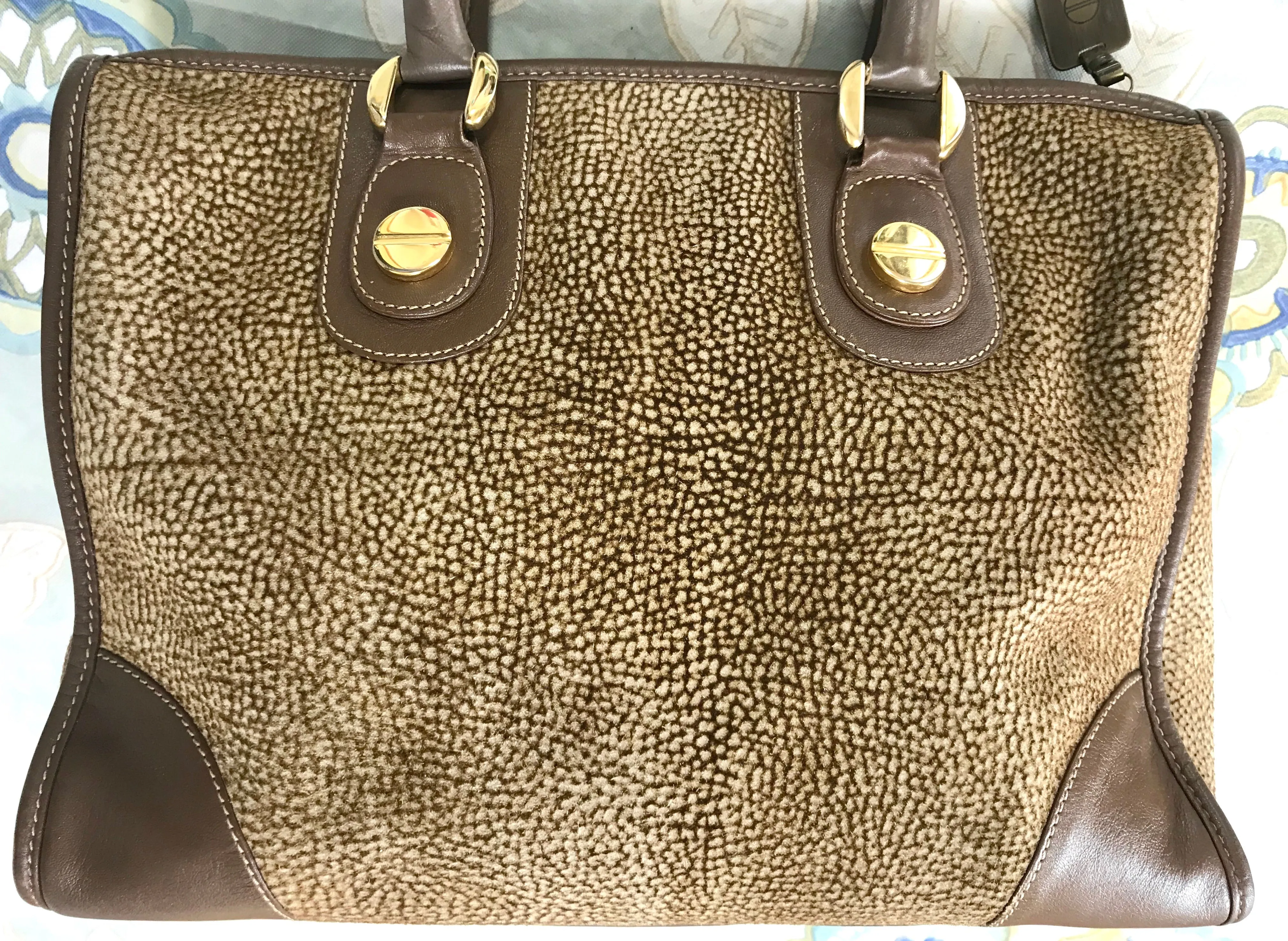 Vintage Borbonese by red wall, brown and beige leather classic bag with golden logo charm.  Unisex use. Masterpiece.